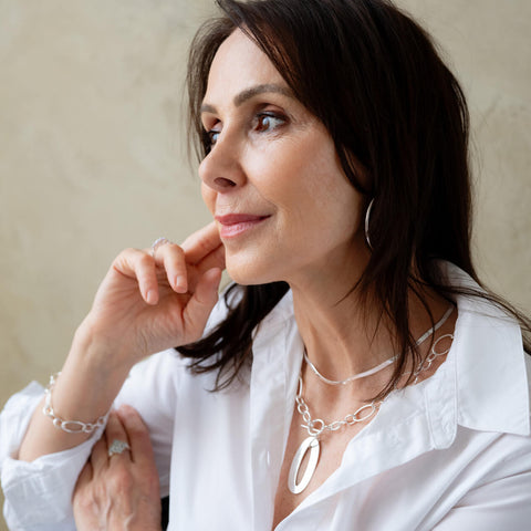 Woman wearing a personalized necklace by CITRUS