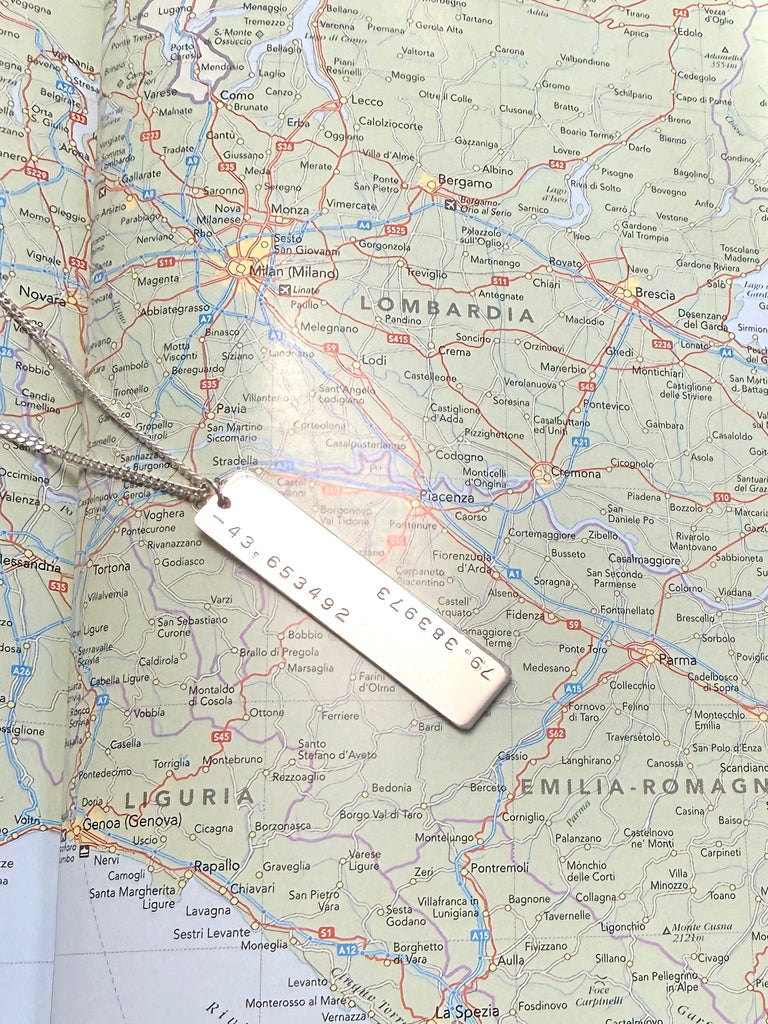 silver necklace stamped with GPS coordinates
