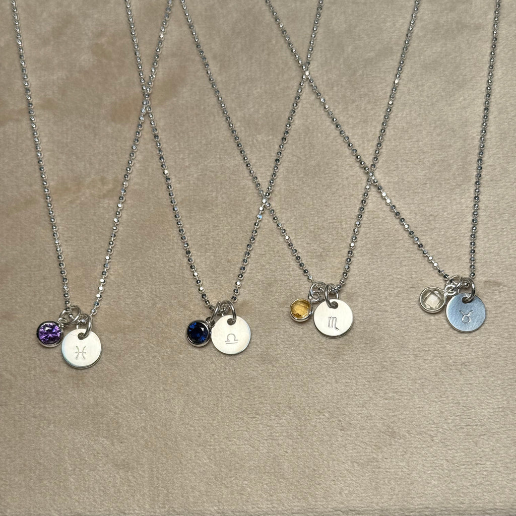 Necklace with various pendant options on a cardboard background