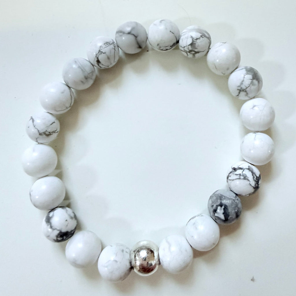 White and gray beaded bracelet on a white background
