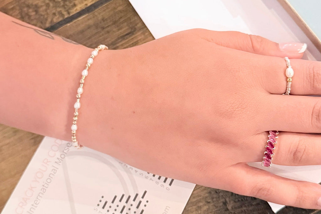 Hand wearing a morse code bracelet by CITRUS