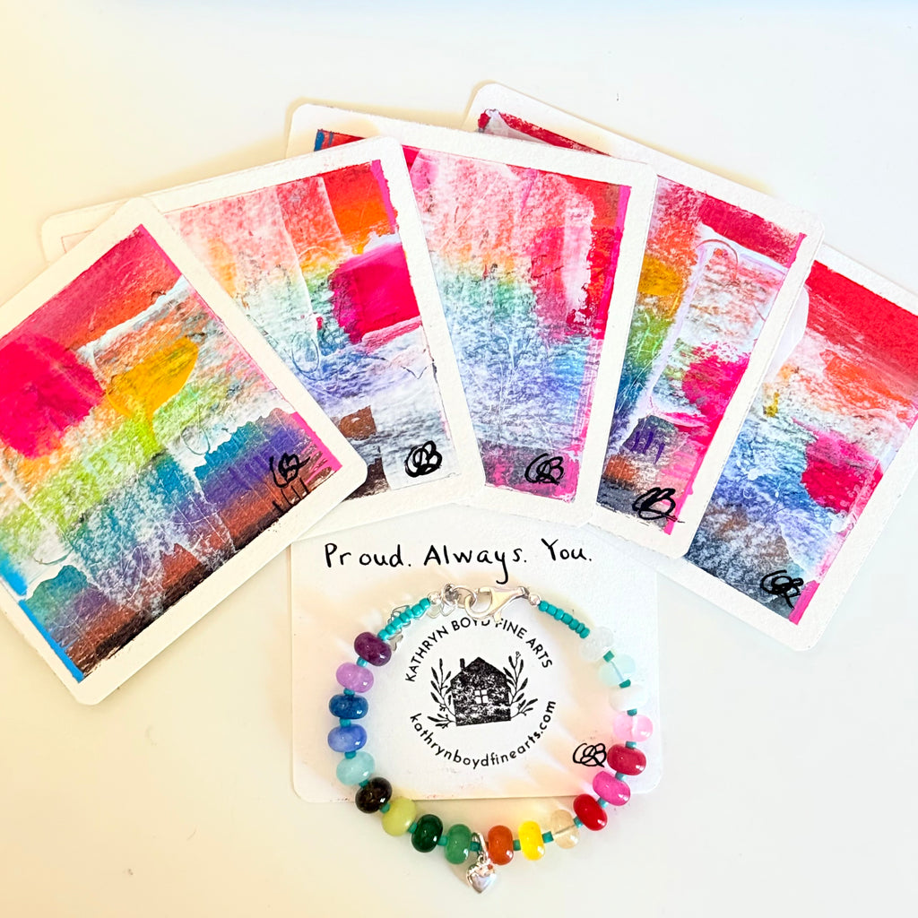 Colorful art cards with a bracelet on a white background
