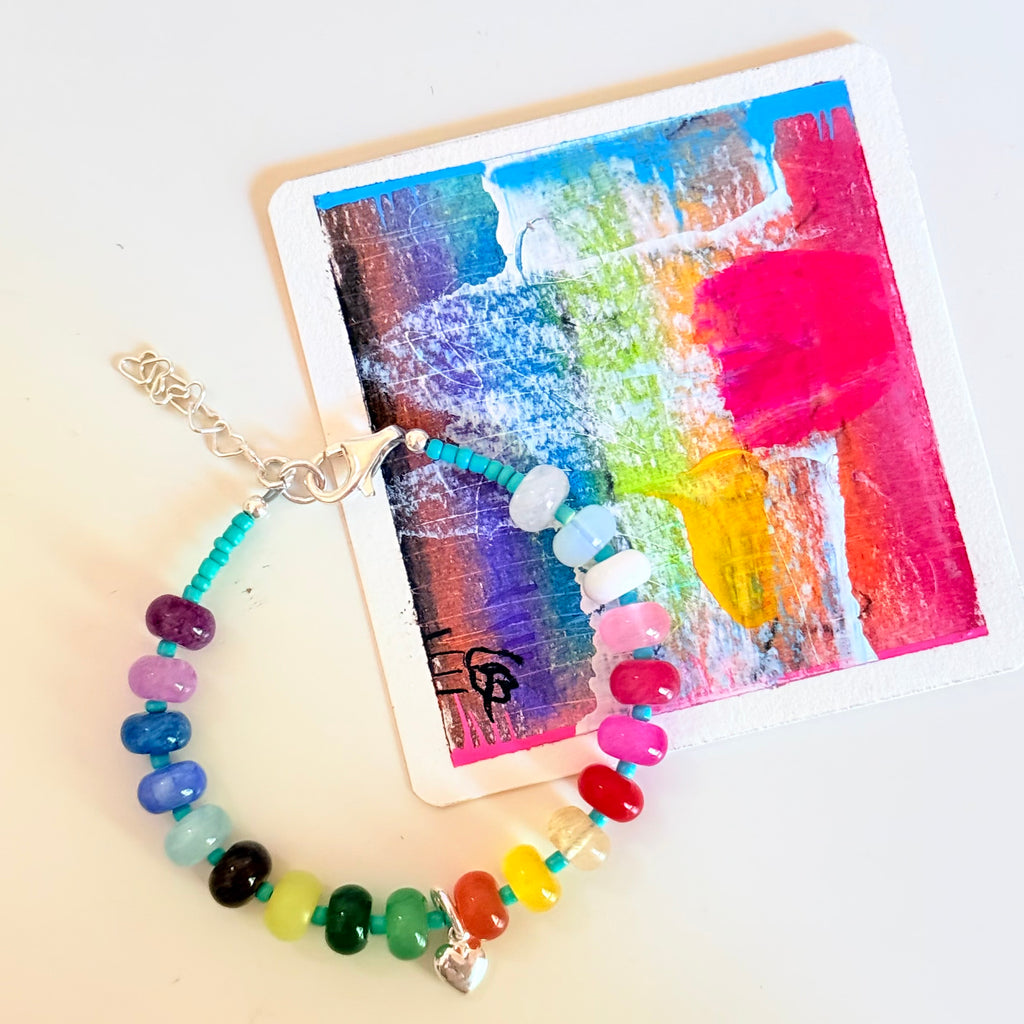 Colorful beaded bracelet on a colorful abstract painting background